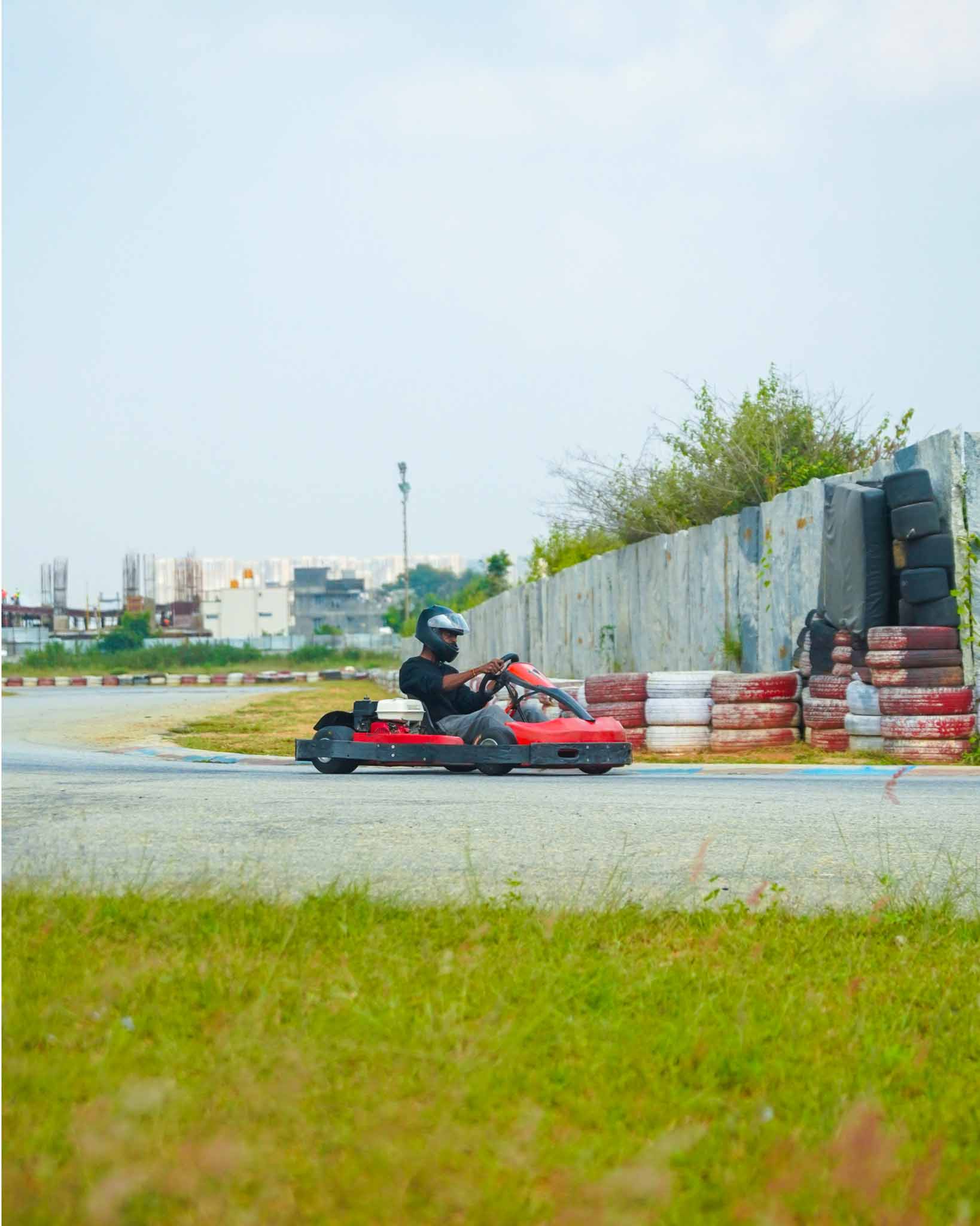 A solitary go-kart navigating a turn on the track.